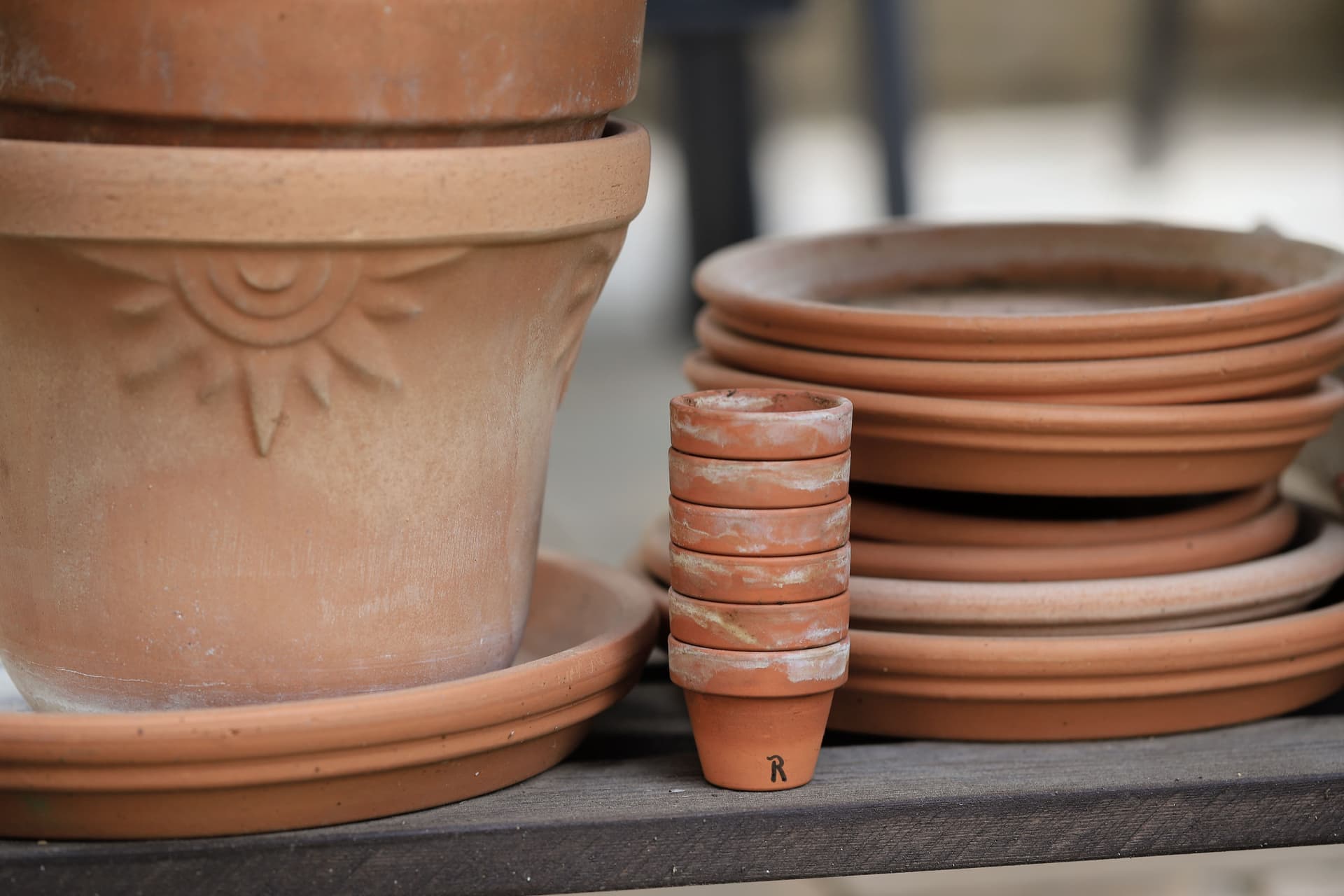 Terracotta pots of increasing size stacked on a shelf